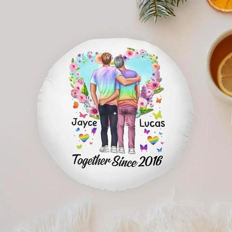 Two people embracing on a personalized pillow adorned with flowers - a heartwarming symbol of love for a gay couple's Valentine's or anniversary celebration